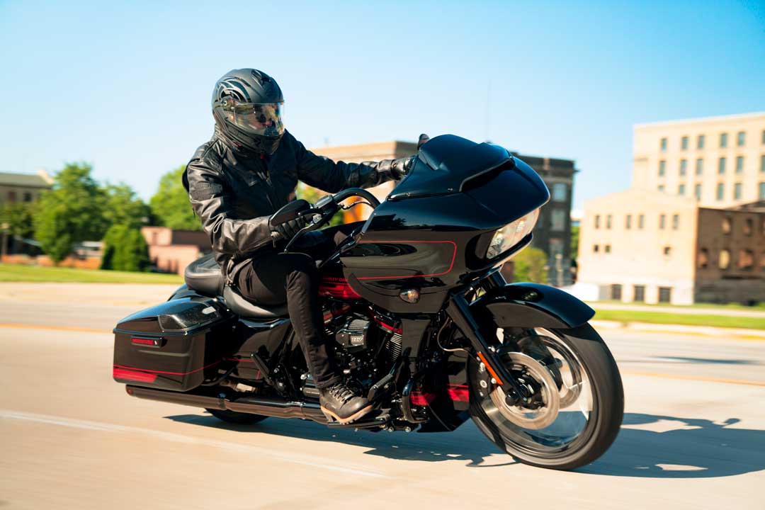 Black Harley-Davidson® LFTRXSE (CVO) profile with rider wearing helmet